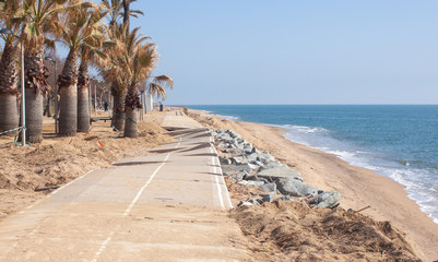 The storm broke the concrete slabs of the bike path on the beach.