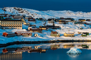 Houses in Ilulissat reflecting in water. Greenland © Mikael