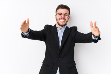 Young caucasian business man posing in a white background isolated Young caucasian business man feels confident giving a hug to the camera.