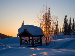 Dawn in the ski resort Mountain Salanga. Lyrical winter landscape. Frosty morning in Siberia