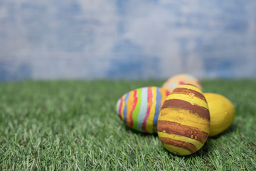 Easter eggs colored on grass top view or flat 