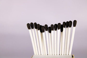 A creative concept of a wax match box with with stick and black head 