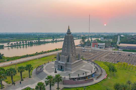 Aerial view of Wat Panyanantaram at sunset, a Buddhist temple in Pathum Thani City, Thailand. Thai architecture buildings background in travel trip concept. Buddhism religion. Tourist attraction.