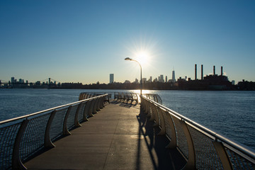 Empty Pier at Transmitter Park in Greenpoint Brooklyn New York over the East River with a view of the Manhattan Skyline before Sunset