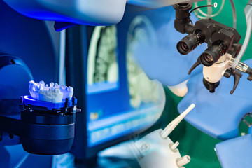 Dental concept. Modern equipment for dental clinics. Prosthetic dentistry. Performing operations under a microscope. Grinding and milling machine of the dentures. Milling cutter for dental work.