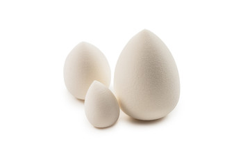 Small, medium and large  white beauty blender isolated.