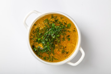 soup of sturgeon. Ear in a white high plate with two handles. Top with parsley