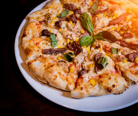 Tasty pizza with chicken and vegetables. Restaurant.