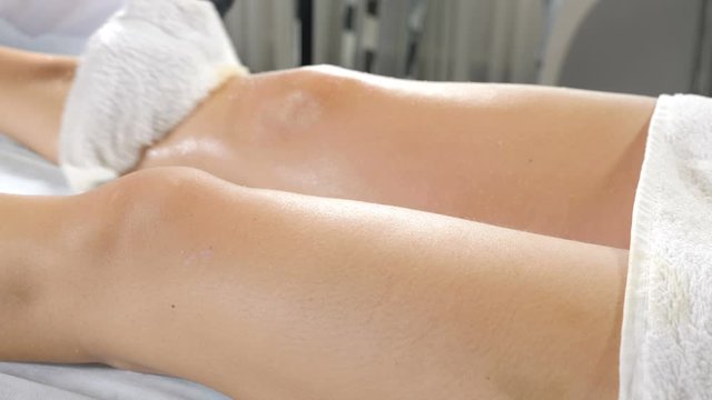 Hands of massage therapist in spa beauty salon making massage to young unidentified woman. Close-up. Concept of body care and beauty. massage of buttocks, cellulitis prevention. Beautician hands in