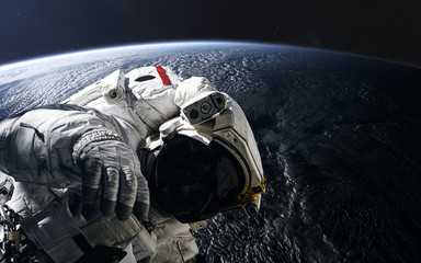 Astronaut in orbit of the Earth. Solar system. Science fiction. Elements of this image furnished by...