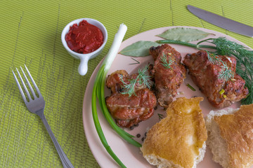 Plate with grilled meat skewers, bread and spices. Harmful and hazardous food containing carcinogens.