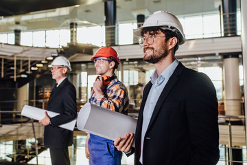 Business meeting of architects and investors in modern factory.