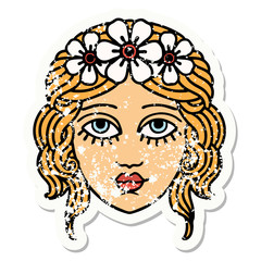 traditional distressed sticker tattoo of female face with crown of flowers