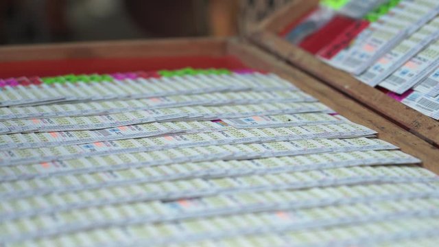 Closeup hand selling lotto in Thailand
