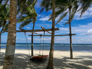 A hanging bed invites to relax in the shadows of the burning sun on Bohol