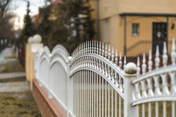 row of white picket fence