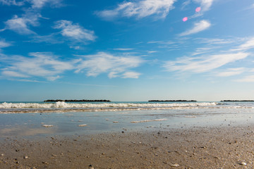 Sandy beach with waves and dams, Porto San Giorgio, Italy