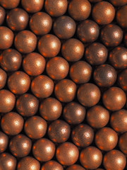 Many balls for shooting from an air gun. Top view from above. Vertical background or wallpaper. Macro