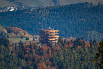 Tree top observation tower in resort town Krynica-Zdroj in autumn. View from Jaworzyna Krynicka Mountain.