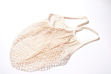 Empty reusable shopping string bag on white. Zero waste concept.