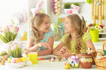 Obraz na płótnie Canvas Sisters preparing for Easter in the kitchen