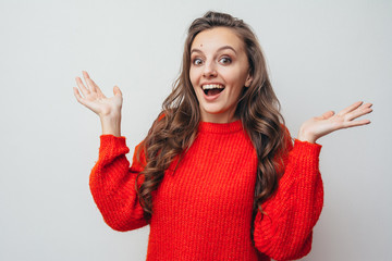 Girl in a red sweater smiles.