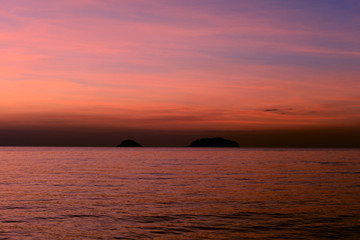 Naklejka na ściany i meble Beautiful sunset at the beach in the tropics. Sky and ocean