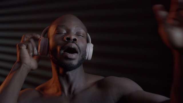 Black Man Listening Music In Headphones.