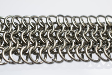 Chain mail on white background. 4 in 1 weave.  