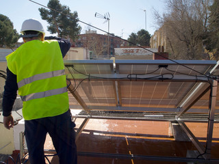 Caucasian seasoned technician repairing and cleaning the solar panels