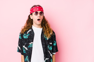 Young hippie caucasian man isolated being shocked because of something she has seen.