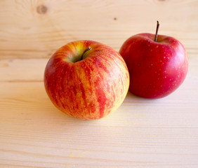 red tasty Sicilian apples on the on the wooden background, top view. Healthy lifestyle, vitamins and Mediterranean diet.