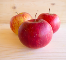 red tasty Sicilian apples on the on the wooden background, top view. Healthy lifestyle, vitamins and Mediterranean diet.