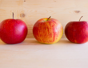 red tasty Sicilian apples on the on the wooden background, top view. Healthy lifestyle, vitamins and Mediterranean diet.
