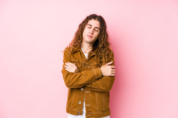 Young long hair man posing isolated hugs, smiling carefree and happy.