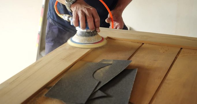 Woodworking. Sanding on Wooden door in 4k slow motion