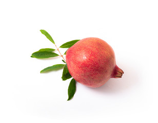 Red pomegranate with green leaves isolated on white background