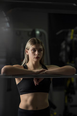 Fototapeta na wymiar Portrait of a girl in a fitness room near the simulator.