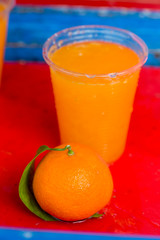 Orange juice on red background, Morocco 