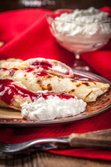 Rolled crepes stuffed with cottage cheese.