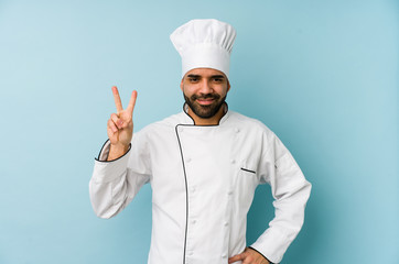 Young latin chef man isolated showing number two with fingers.