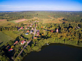 Aerial view of beautiful Kuty village (former Kutten, East Prussia) located on Czarna Kuta Lake shore, Mazury, Poland - obrazy, fototapety, plakaty