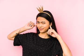 Young chinese princess woman isolated on a pink background having some great idea, concept of creativity.