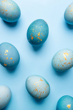 Easter background of eggs painted in blue color. Flat lay, top view.