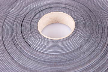 Fototapeta na wymiar Gray roll of adhesive tape to seal