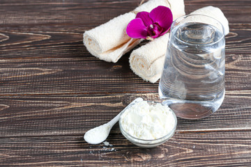 Collagen powder in half coconut with a spoon for measuring quantity. Extra protein intake. Natural supplements for beauty and health. Collagen based plant concept. Flatlay, top view.