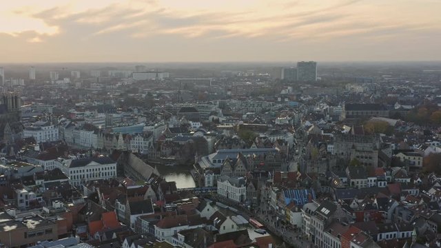 Ghent Belgium Aerial v14 Flying around over neighborhood town with downtown church cityscape views at sunset - November 2019