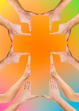 hands making cross symbol, religious sign on rainbow colors background