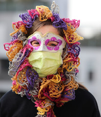 little girl with health mask and carnival mask for protection against the Virus crown
