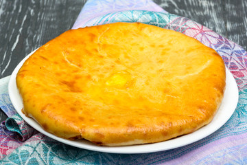 Yeast dough pie with cheese and butter, traditional Ossetian cuisine